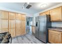 A spacious kitchen with hardwood-style floors features a refrigerator and wood cabinets at 505 W Howe St, Tempe, AZ 85281