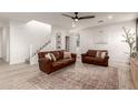 Bright living room featuring hardwood floors, two leather couches, and neutral walls at 5460 S Dillon Cir, Mesa, AZ 85212