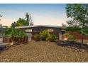 Charming single-story home featuring desert landscaping, unique rusted steel accents, and a neutral color scheme at 5739 N 11Th St, Phoenix, AZ 85014