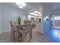 Dining area with wooden table and views into kitchen with stainless appliances at 6044 W Augusta Ave, Glendale, AZ 85301