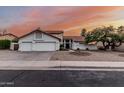 Lovely two-story home with a three-car garage, complemented by desert landscaping at 6133 E Saddleback St, Mesa, AZ 85215