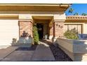 Charming home entrance featuring a brick-accented porch and welcoming 'hello' wreath on the front door at 650 E Silver Creek Rd, Gilbert, AZ 85296