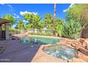 Resort-style pool and spa with rock accents, perfect for relaxation and outdoor enjoyment at 715 N Cholla St, Chandler, AZ 85224