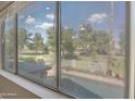 A beautiful view of the fenced in pool and landscape from inside the home at 715 N Cholla St, Chandler, AZ 85224