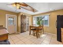 Dining area featuring tile floors, natural light, and a sliding barn door to the pantry at 7250 E Mckellips Rd, Scottsdale, AZ 85257