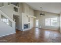 Spacious living room with fireplace, staircase, and large windows for natural light and stained concrete floor at 823 W Bradford Dr, Gilbert, AZ 85233