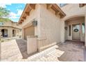 Home exterior featuring brick driveway and covered entryway at 9017 E June Cir, Mesa, AZ 85207