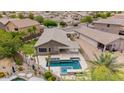 Aerial view of a well-maintained home with a private backyard, pool, and covered outdoor kitchen at 10261 W Foothill Dr, Peoria, AZ 85383
