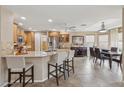 Open kitchen features granite countertops, stainless steel appliances, and a breakfast bar with seating at 11320 E Newcastle Ave, Mesa, AZ 85209