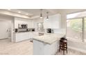 Bright kitchen with stainless steel appliances, white cabinetry, and a stylish breakfast bar with seating at 14058 S 24Th Way, Phoenix, AZ 85048