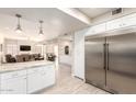 Open kitchen featuring stainless steel refrigerator, leading to dining and living spaces at 14058 S 24Th Way, Phoenix, AZ 85048