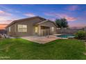 Well-manicured backyard featuring a fenced pool and green grass, perfect for outdoor enjoyment at 14676 W Banff Ln, Surprise, AZ 85379