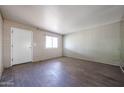 A simple, bright living room with fresh paint and flooring and a large window at 1614 S 6Th Ave, Phoenix, AZ 85003