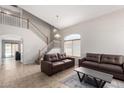 Inviting living room featuring high ceilings, staircase and tile flooring, with lots of natural light at 1632 E Leslie Ave, San Tan Valley, AZ 85140