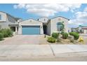 Charming single-story home featuring a well-manicured front yard and a blue two car garage door at 1865 N 141St Ave, Goodyear, AZ 85395