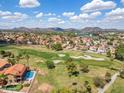Aerial view of a house near a golf course with mountain views in the distance at 18851 N 69Th Ave, Glendale, AZ 85308