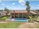 Spacious backyard with a pool, putting green, and outdoor seating area at 18851 N 69Th Ave, Glendale, AZ 85308