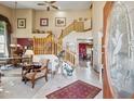 Grand foyer with soaring ceilings, a wood staircase, and tile flooring at 18851 N 69Th Ave, Glendale, AZ 85308