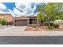 Charming home featuring a well-manicured lawn, a two-car garage, and tasteful desert landscaping at 2111 E Yellowstone Pl, Chandler, AZ 85249
