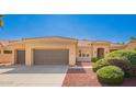 Charming single-story home featuring a two-car garage, neutral colors, and tidy landscaping at 22222 N Pedregosa Dr, Sun City West, AZ 85375