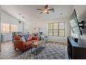 Bright living room featuring vaulted ceilings, wood-look floors, a ceiling fan, and a large window at 2731 E Windsor Ave, Phoenix, AZ 85008