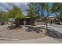 Single story home with a two car garage, desert landscaping, and a covered entry at 29058 N Cactus Cir, San Tan Valley, AZ 85143