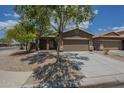 Single story home featuring a two car garage, desert landscaping, and a sidewalk in front at 29058 N Cactus Cir, San Tan Valley, AZ 85143