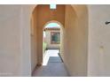 Arched entry leading to the home with a view of the front yard and landscaping at 36255 W Marin Ave, Maricopa, AZ 85138