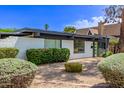 Well-maintained home featuring white brick, manicured shrubbery, and a gravel yard for easy care at 3710 E Altadena Ave, Phoenix, AZ 85028