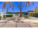 Beautifully landscaped home with modern architectural details, carport, and a charming front exterior at 3710 E Altadena Ave, Phoenix, AZ 85028