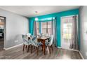 Dining area with table, chairs, large windows, and bright accent wall paint at 3723 W Columbine Dr, Phoenix, AZ 85029