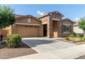 Attractive single-story home with a stone accent wall, desert landscaping, and a wide driveway at 3894 E Dogwood Pl, Chandler, AZ 85286