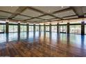 A large room with hardwood floors, stone columns, lots of windows, and recessed lighting at 3931 E Crest Ln, Phoenix, AZ 85050