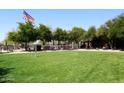 Professionally maintained sand volleyball court with an American flag blowing in the wind at 3931 E Crest Ln, Phoenix, AZ 85050