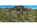 Contemporary home features a pool, outdoor fireplace, and seating at 39878 N 105Th Way, Scottsdale, AZ 85262