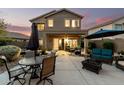 Spacious backyard patio with stylish outdoor furniture, including dining and seating areas and a built in fire pit at 40807 N Barnum Way, Anthem, AZ 85086