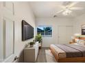 Modern bedroom with neutral-toned walls, ceiling fan, and a sliding door closet at 41344 W Laramie Rd, Maricopa, AZ 85138