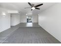 Spacious, airy living area featuring neutral carpets and tile leading to a patio entrance at 4607 W Becker Ln, Glendale, AZ 85304
