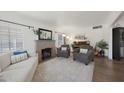 Bright living room featuring a charming fireplace, cozy seating, and large windows for ample natural light at 530 W Almeria Rd, Phoenix, AZ 85003