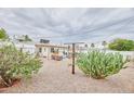 Spacious backyard with desert landscaping, an outdoor seating area, and mature cacti at 5410 E University Dr, Mesa, AZ 85205