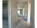 Unfinished hallway features blank drywall and leads to a bright opening, showing the building's progress at 5515 W Piedmont Rd, Laveen, AZ 85339