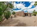 Expansive backyard with desert landscaping, mature trees, and covered patio, perfect for outdoor living at 5526 N 77Th Way, Scottsdale, AZ 85250