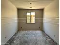 Unfinished bedroom features drywall, a window, and electrical outlets ready for customization at 5610 W Hopi Trl, Laveen, AZ 85339