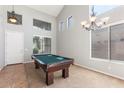 Spacious game room features a pool table, high ceilings, and lots of natural light at 567 E Tropical Dr, Casa Grande, AZ 85122