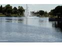 Scenic lake view featuring a fountain and landscaped walking areas at 567 E Tropical Dr, Casa Grande, AZ 85122
