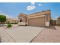 A one-story home featuring a two-car garage and low-maintenance desert landscaping in a quiet neighborhood at 5815 E Nora St, Mesa, AZ 85215