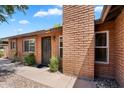 Side angle of a single-story brick home with a covered front entrance and desert landscaping at 6416 S Kenneth Pl # D, Tempe, AZ 85283