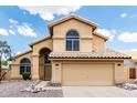 Charming two-story home featuring a double garage, tile roof, and a neutral color scheme for a welcoming curb appeal at 6516 E Rochelle St, Mesa, AZ 85215