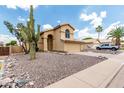 Beautiful home featuring desert landscaping, including a mature Saguaro cactus, for a classic Southwest style at 6516 E Rochelle St, Mesa, AZ 85215