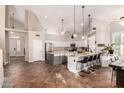 Bright, open kitchen with vaulted ceilings, stainless steel appliances, and a large center island with bar seating at 7029 E Monte Cir, Mesa, AZ 85209